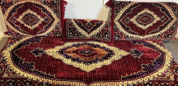 Intricately Patterned Red And Gold Textiles With Geometric And Ornate Details.