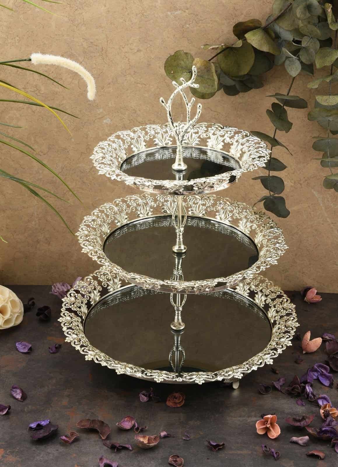 Three-Tiered Metal Stand With Filigree, Dried Petals On Neutral Background.