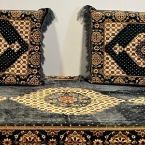 Traditional black and gold seating set with intricate geometric and floral patterns.