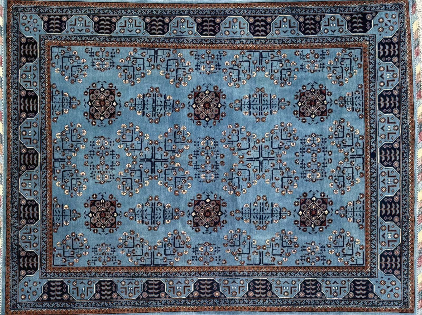 Decorative Rug With Blue Background, Intricate Geometric Patterns, And Symmetrical Motifs.