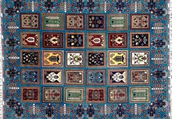 Decorative Carpet With Multiple Square Sections Featuring Geometric And Floral Designs.