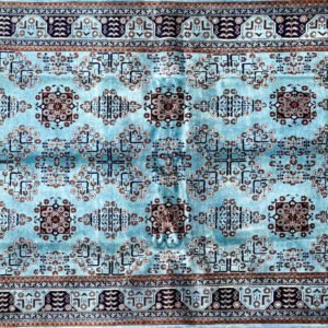Rectangular rug with blue, brown, ivory geometric pattern and detailed decorative border.