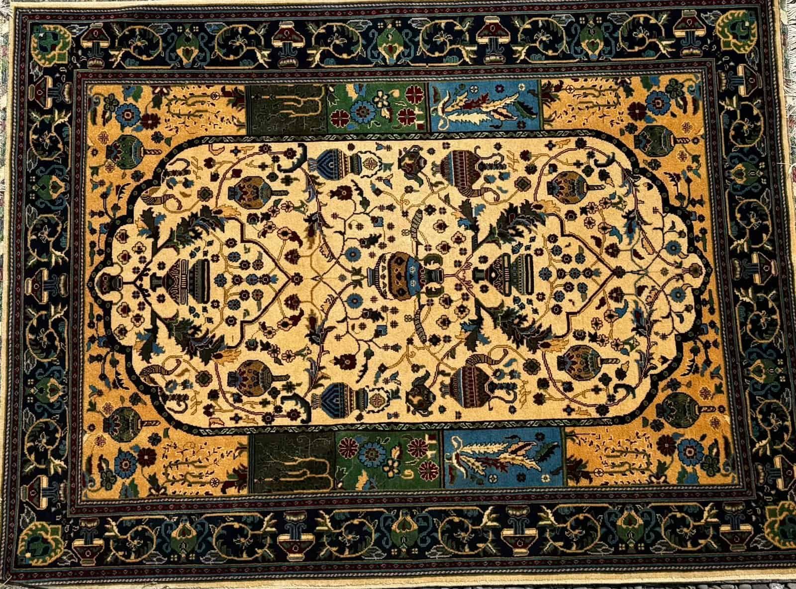Intricate Woven Carpet With Floral And Geometric Patterns In Gold, Blue, Green, And Black.