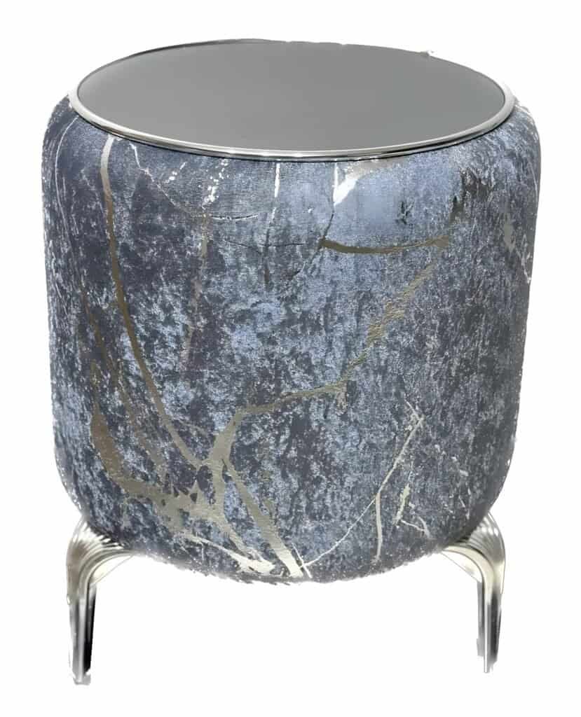 Velvet Puff Tables - The Hero Your New Zealand Home Decor Needs 3 Cylindrical Stool With Silver-Blue Metallic Abstract Design, Mirrored Top, And Curved Legs.