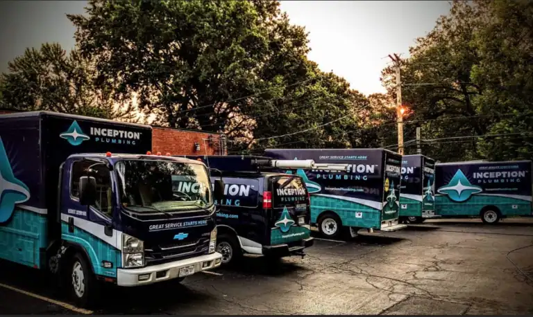 Several Inception Plumbing trucks are parked in a lot near trees and a brick building, with company branding visible on each vehicle.