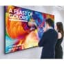 A feast of vibrant colorful artwork displayed on a large interactive digital screen at an art exhibition.
