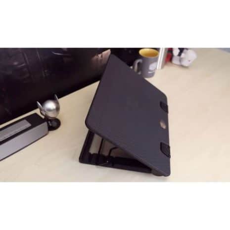 Lightweight black laptop with textured cover on a wooden desk, partially open for use, representing innovative and affordable technology solutions in South Africa.