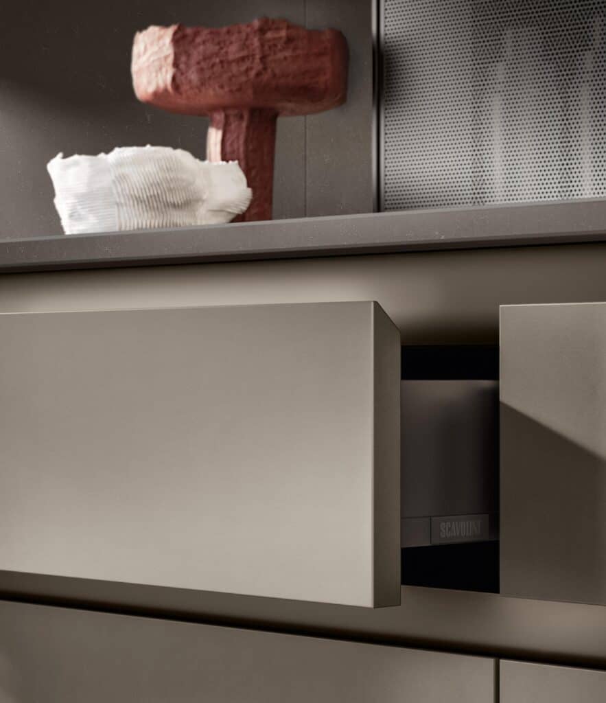 Modern kitchen cabinet with sleek, matte finish and opened drawer, revealing interior.