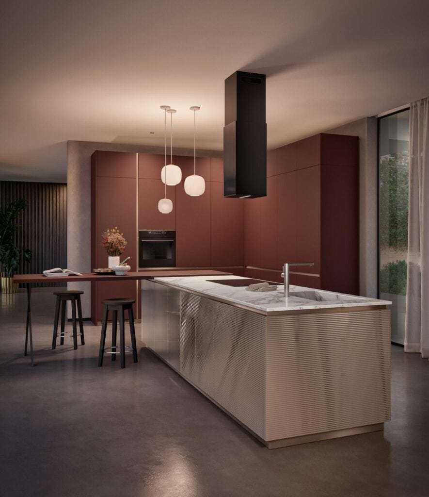 Modern kitchen with maroon cabinets, a central island with a marble countertop, pendant lights, and bar stools.