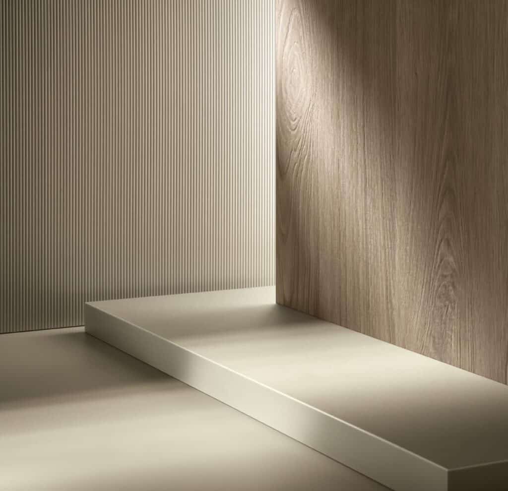 Textured beige surfaces with wood grain and vertically ribbed patterns in a minimalist interior setting.