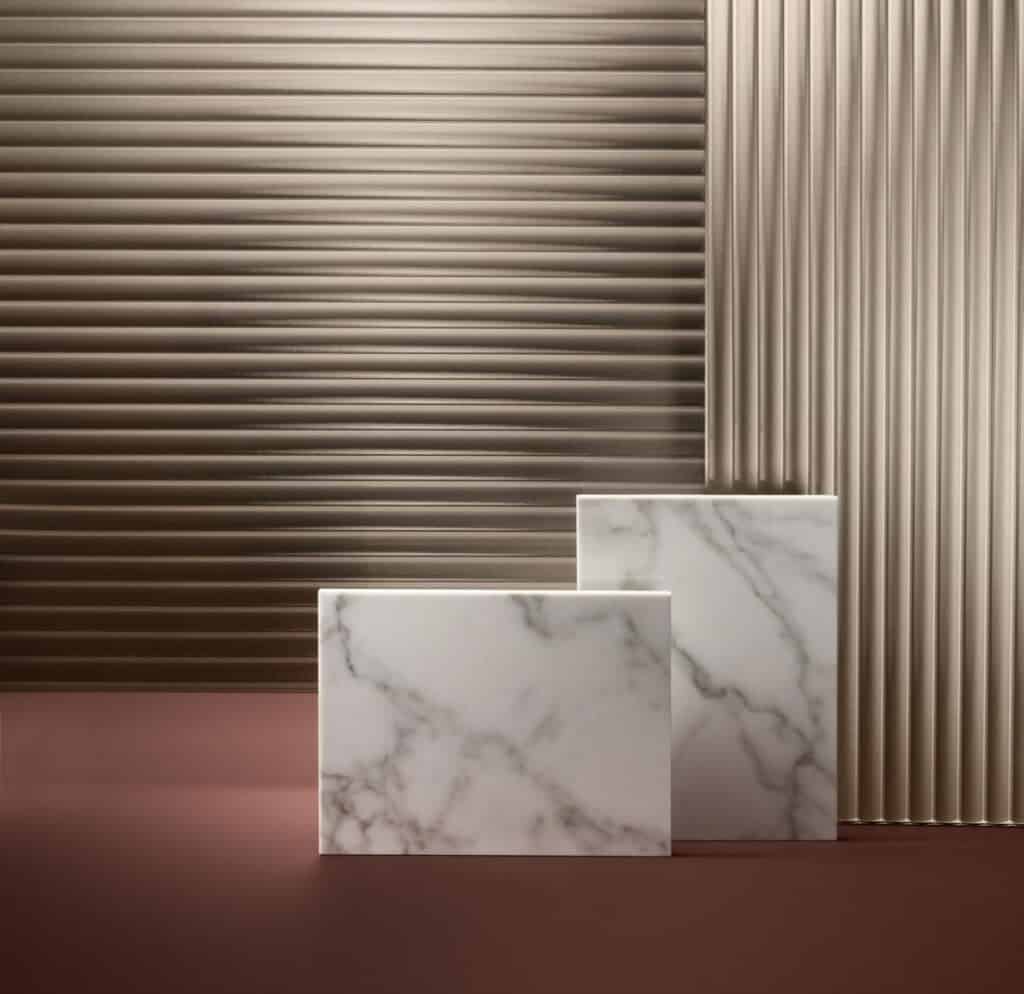 Marble slabs with a brown, ribbed backdrop.