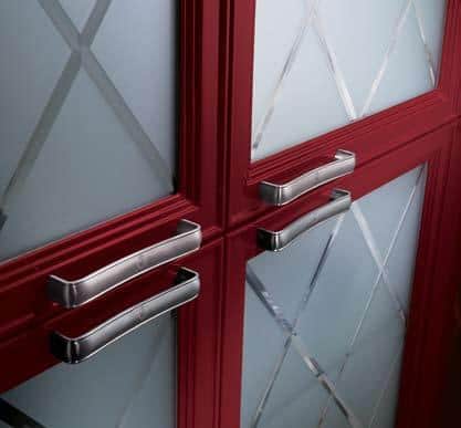 Red cabinet doors with frosted glass panels and silver handles.