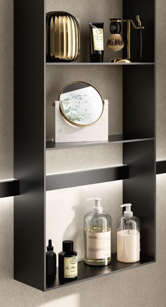 A bathroom shelf with grooming products, a small mirror, and a golden decorative item.