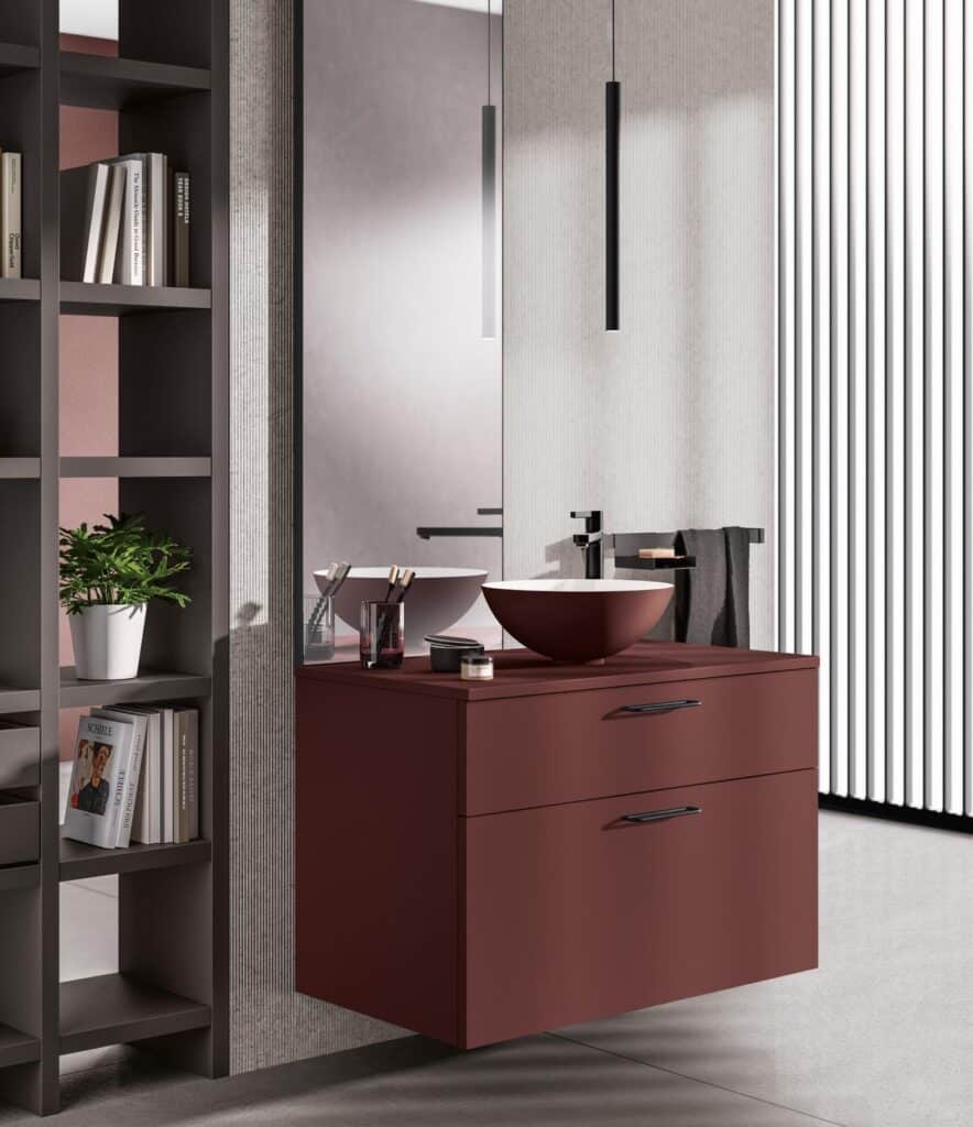 Modern bathroom vanity with a burgundy cabinet and countertop, featuring a round basin, black faucet, and minimalistic decor.