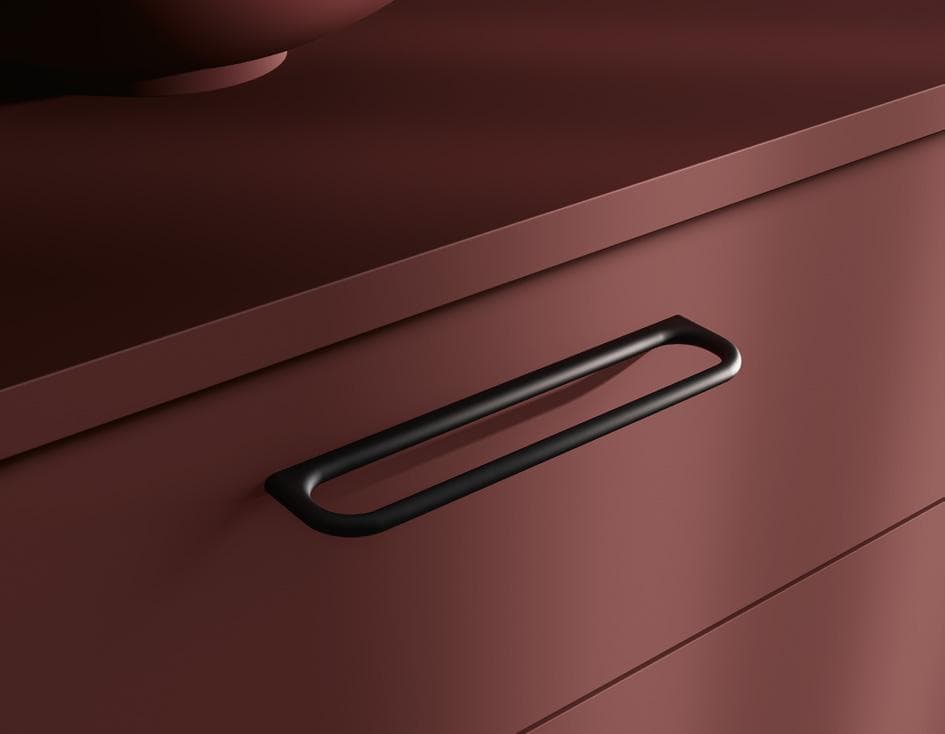 Close-up of a matte brown cabinet drawer with a sleek black handle.