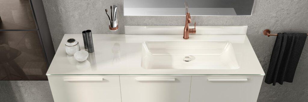 Modern bathroom sink with a rose gold faucet, white countertop, and wall-mounted toothbrush holder.