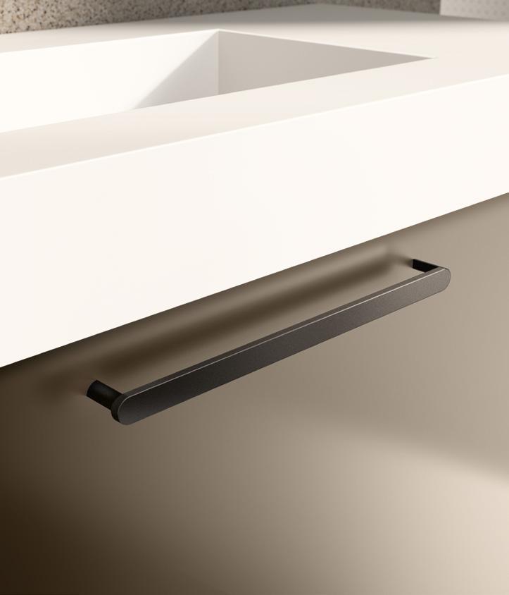 Close-up of a minimalist cabinet pull handle on a light-colored surface.