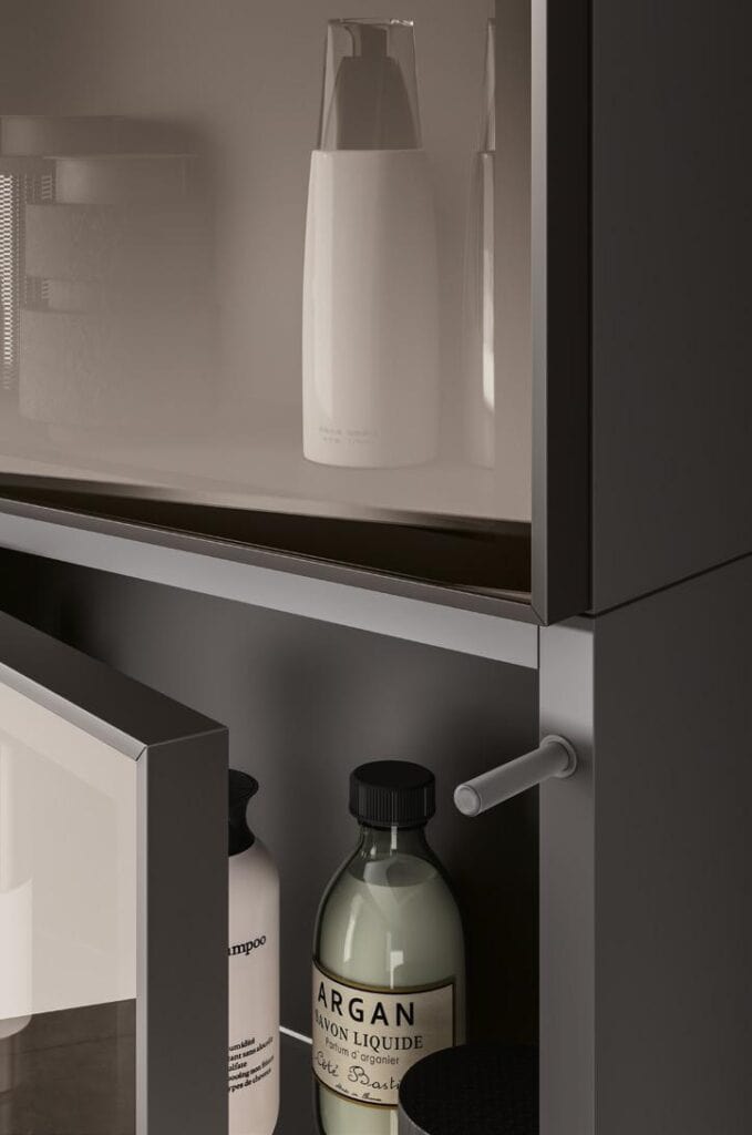 Bathroom cabinet with partially opened door, displaying various bottles and containers inside.