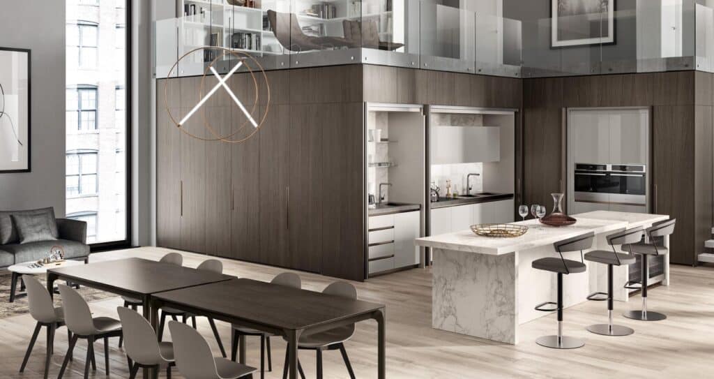 Modern open-plan kitchen and dining area with marble island, dark wood cabinetry, loft seating, and contemporary lighting.