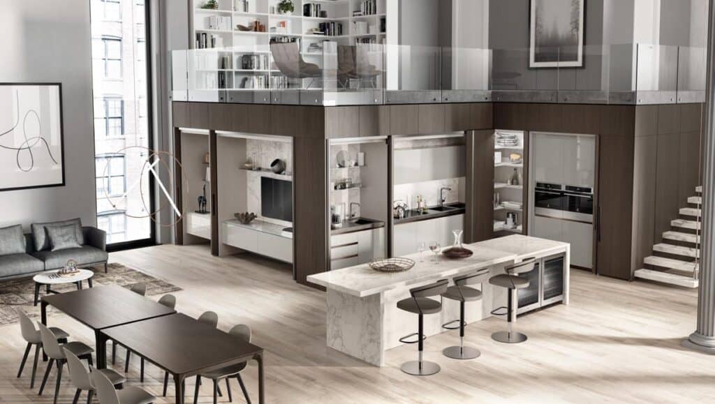 Modern open-plan living space with a kitchen, dining area, and lofted bookshelf with seating, featuring sleek furniture and marble countertops.