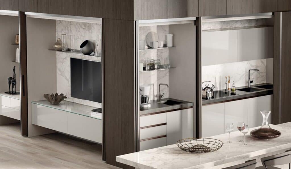 Modern kitchen interior with marble countertops, stainless steel sinks, and sleek cabinetry.
