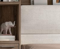 BoxLife_Book_Tecnico-6 - Inspo Living Spaces A wooden shelf with a small elephant figurine and books beside a beige upholstered headboard.