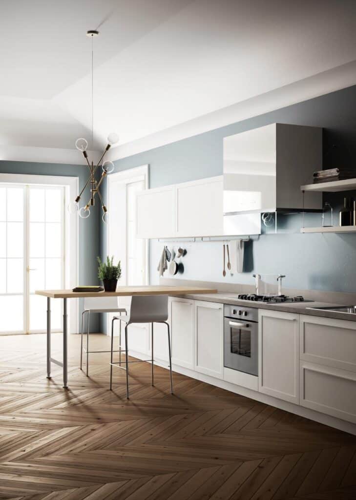 Modern kitchen with white cabinetry, wooden flooring, a minimalist pendant light, and a small breakfast bar.