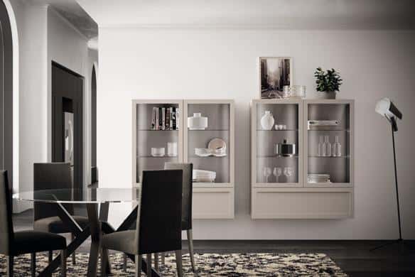 Modern dining room with glass table, dark chairs, wall-mounted display cabinets, and floor lamp.