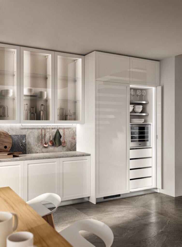 Modern kitchen with white cabinetry, a built-in appliance, glass cabinet doors, and marble countertops.