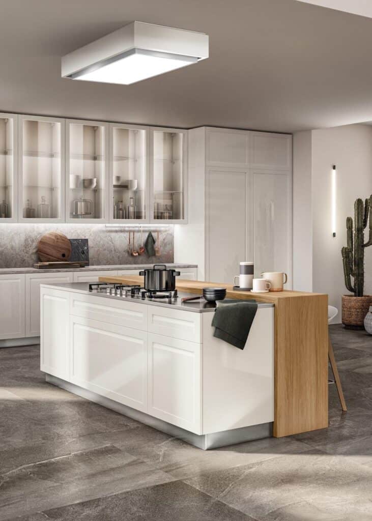 Modern kitchen with a white island, wooden extension, stainless steel appliances, and glass cabinets.