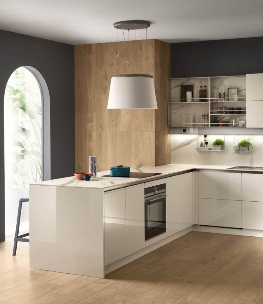 Modern kitchen with white cabinets, wooden accents, an island, and a large overhead light fixture.