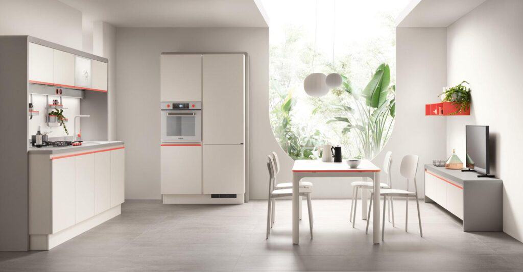 Modern kitchen with white cabinets, a dining table, chairs, an oven, and a large circular window, featuring minimalist decor and greenery.