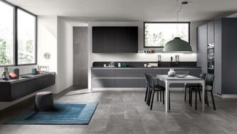 Modern kitchen with gray cabinets, a dining table with four chairs, and large windows providing natural light.