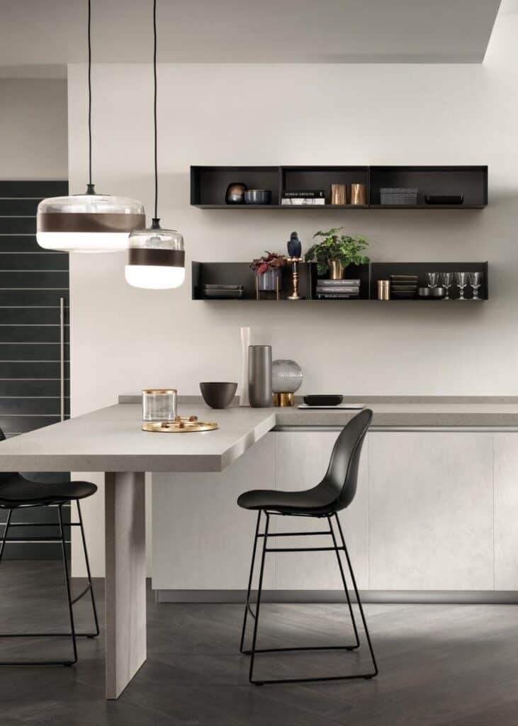 Modern kitchen interior with a sleek bar counter, high chairs, pendant lights, and minimalist shelving.