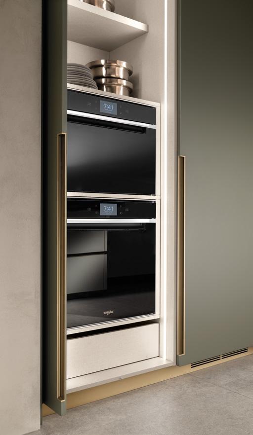 Built-in kitchen oven with digital display and metallic handles, stacked shelves with dishes above.
