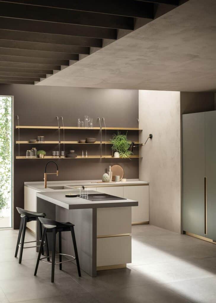 Modern kitchen with a central island, black stools, open shelves with dishes and plants, and a built-in oven.