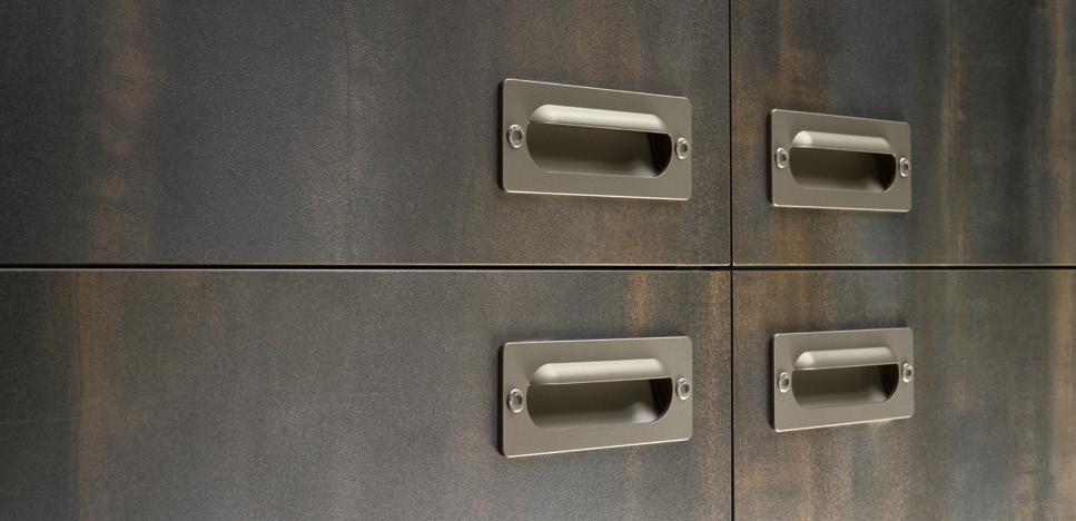 Metallic cabinet doors with rectangular recessed handles.