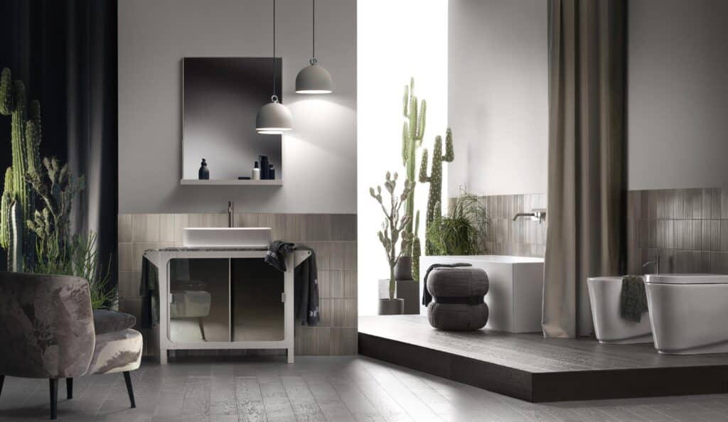 Modern bathroom with a sleek design, featuring a freestanding tub, dual-sink vanity, large mirror, pendant lights, and cactus plants for decor.