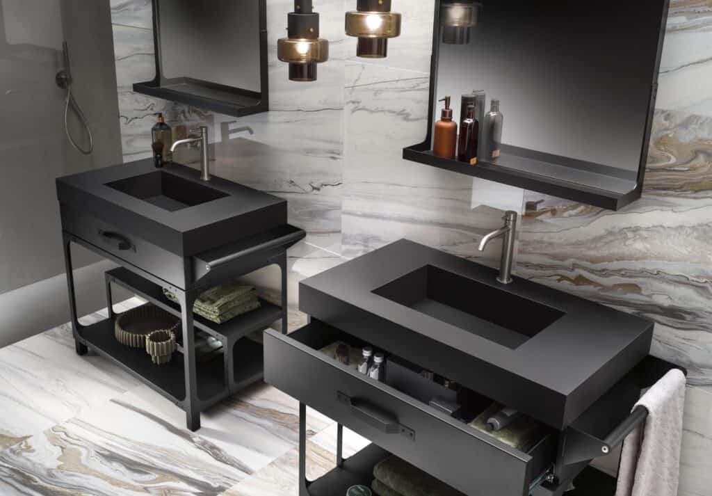 Modern bathroom with two black rectangular sinks, sleek metal faucets, suspended mirrors, and open shelving beneath each sink, set against a marble patterned wall.