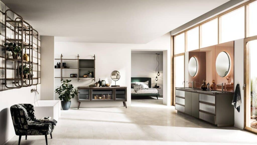 Modern interior with a minimalist bathroom featuring a freestanding bathtub, a wall shelf with plants, a vanity with circular mirrors, and an adjacent bedroom area.