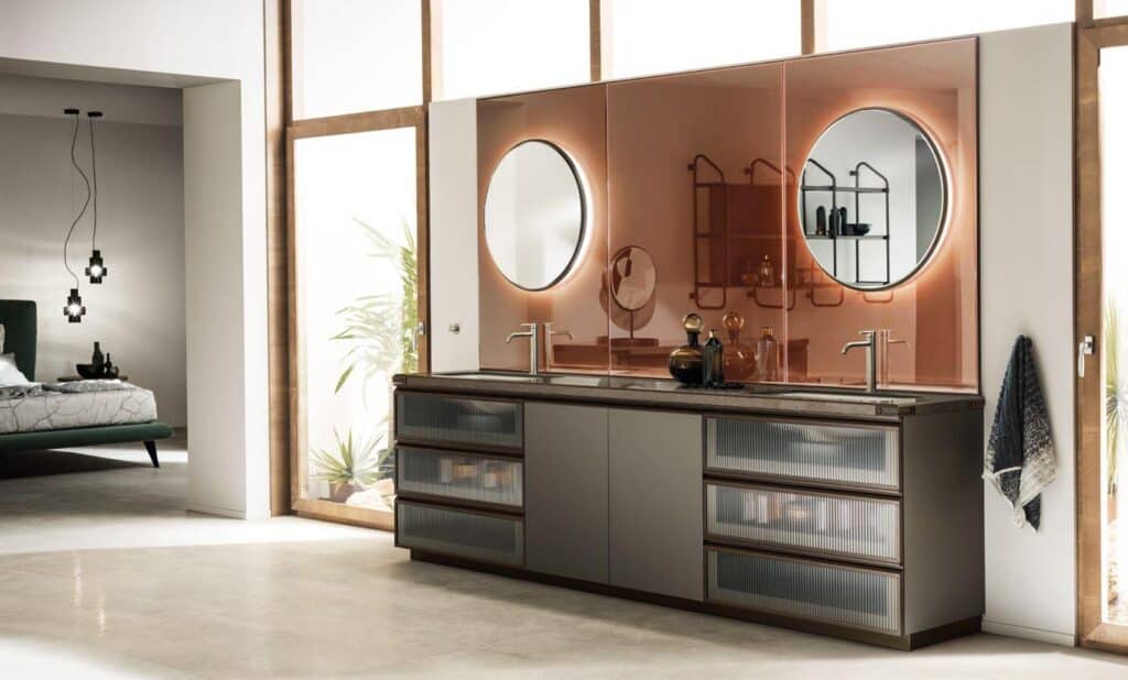 Modern bathroom with dual sinks, circular mirrors, and a sleek vanity cabinet.