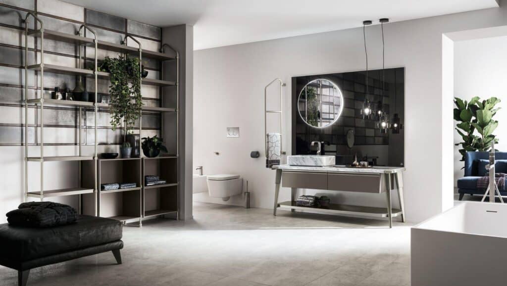 Modern bathroom with a sleek vanity, round mirror, wall-mounted toilet, open shelving with plants, and a freestanding bathtub.
