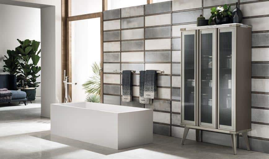 Modern bathroom with a rectangular bathtub, glass cabinet, and decorative plants.
