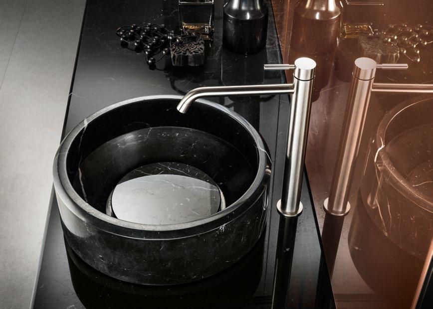 Black marble sink with a sleek, modern stainless steel faucet on a glossy countertop.
