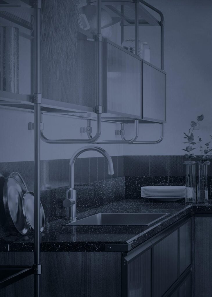 Modern kitchen with metallic fixtures, under-sink cabinet, and black speckled countertop.