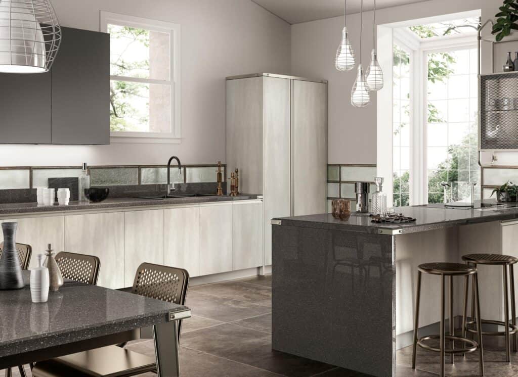 Modern kitchen with neutral tones, featuring glossy countertops, pendant lights, and a large window overlooking greenery.