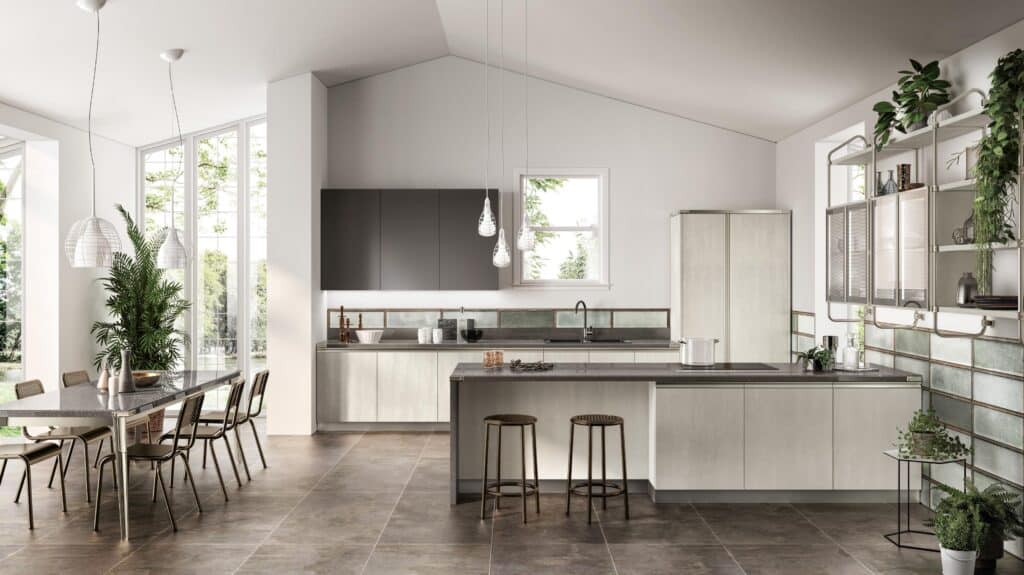 Modern kitchen and dining area with sleek cabinetry, large windows, pendant lights, and greenery.
