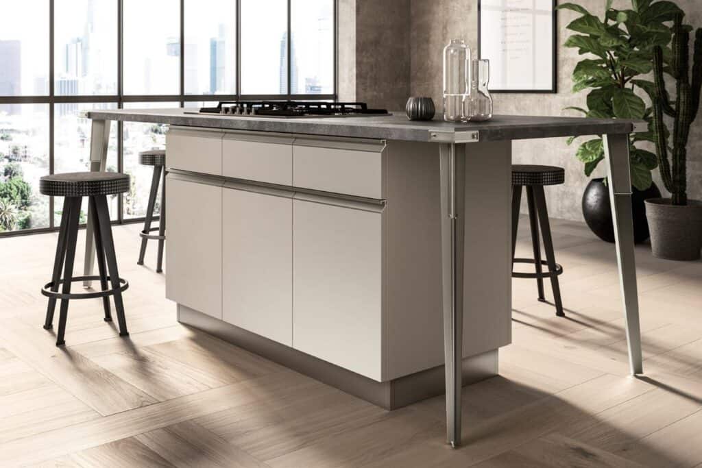 Modern kitchen island with sleek cabinets, bar stools, and large windows in background.