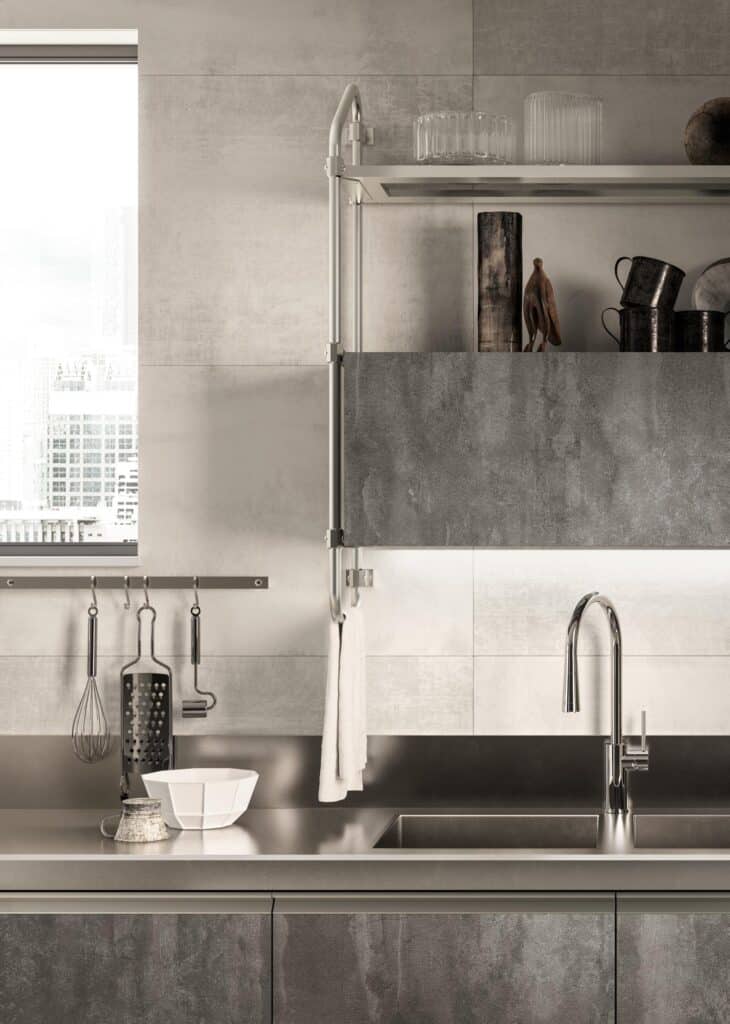 Modern kitchen with stainless steel sink, sleek faucet, industrial-style shelves, and cityscape view.