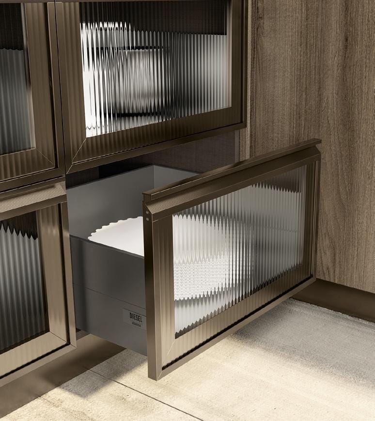 A kitchen cabinet with ribbed glass panel doors, featuring an open drawer with a textured white interior and a &quot;DIESEL&quot; brand label.